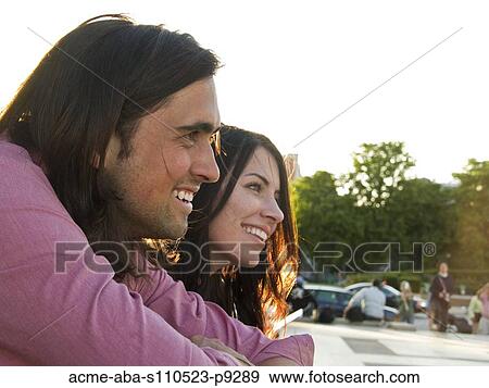 Stock Photo - France, Paris, Young couple looking at view. Fotosearch