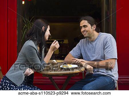 France, Paris, Young couple sitting in sidewalk cafe View Large Photo Image Picture - France, Paris, Young couple sitting in sidewalk cafe. Fotosearch