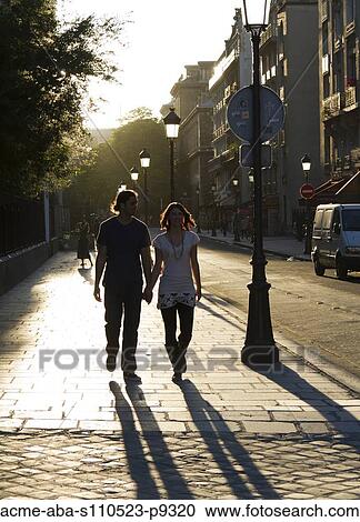 France, Paris, Young couple walking in street View Large Photo Image Stock Image - France, Paris, Young couple walking in street. Fotosearch