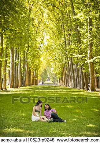 France, Versailles, Couple resting in park View Large Photo Image Stock Photo - France, Versailles, Couple resting in park. Fotosearch