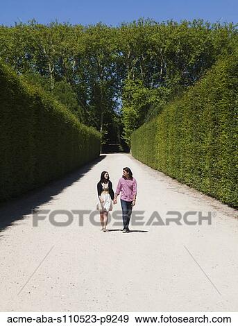 France, Versailles, Couple walking in park View Large Photo Image Stock Photo - France, Versailles, Couple walking in park. Fotosearch