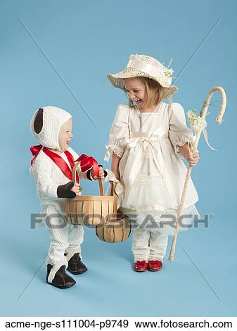 Stock Photo - Girl (2-3) as Little Bo Peep with boy (12-17 months) as lamb for Halloween. Fotosearch