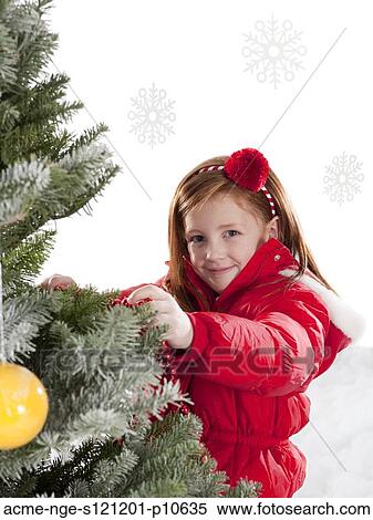 Girl (4-5) decorating Christmas tree View Large Photo Image Stock Photography - Girl (4-5) decorating Christmas tree. Fotosearch