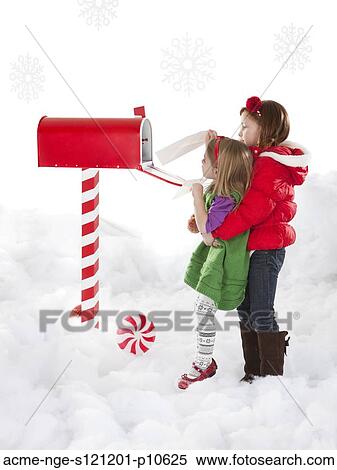 Girl (4-5) is helping sister (18-23months) to send letter View Large Photo Image Stock Photography - Girl (4-5) is helping sister (18-23months) to send letter. Fotosearch