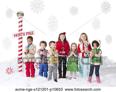 Group of kids (18-23months, 2-3, 4-5, 6-7) standing next to North Pole sign View Large Photo Image Stock Image - Group of kids (18-23months, 2-3, 4-5, 6-7) standing next to North Pole sign. Fotosearch