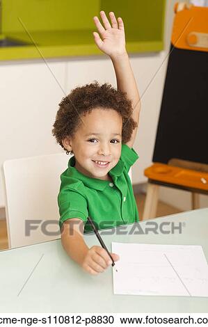 Happy young boy rising hand in classroom View Large Photo Image Stock Image - Happy young boy rising hand in classroom. Fotosearch