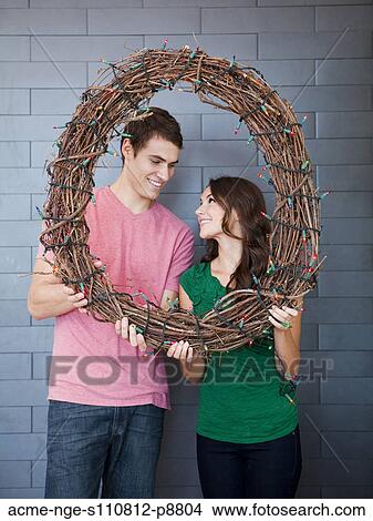 Happy young couple posing with wicker wreath View Large Photo Image Picture - Happy young couple posing with wicker wreath. Fotosearch