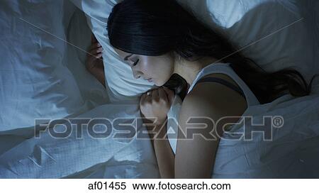 High angle profile view of sleeping woman laying in bed View Large Photo Image Stock Photography - High angle profile view of sleeping woman laying in bed. Fotosearch