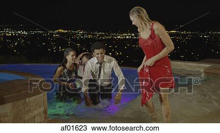 High angle selective focus view of laughing friends partying and playing in hot tub on balcony overlooking scenic view of landscape View Large Photo Image Stock Image - High angle selective focus view of laughing friends partying and playing in hot tub on balcony overlooking scenic view of landscape. Fotosearch