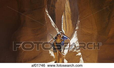 High angle view of boyfriend and girlfriend exploring cave in scenic rock formations View Large Photo Image Stock Photograph - High angle view of boyfriend and girlfriend exploring cave in scenic rock formations. Fotosearch