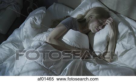 High angle view of relaxed woman dreaming and sleeping under duvet in bed View Large Photo Image Stock Photography - High angle view of relaxed woman dreaming and sleeping under duvet in bed. Fotosearch