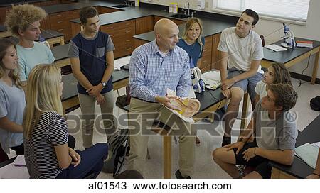 High angle view of teacher instructing students with diorama in science lab classroom View Large Photo Image Stock Image - High angle view of teacher instructing students with diorama in science lab classroom. Fotosearch