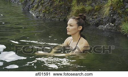High angle view of woman in bikini sitting in remote pool of water View Large Photo Image Stock Image - High angle view of woman in bikini sitting in remote pool of water. Fotosearch