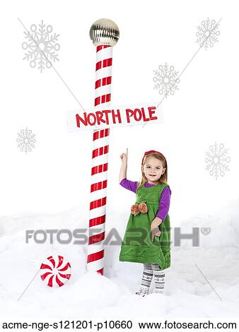 Little girl (18-23 months) standing next to North Pole sign View Large Photo Image Stock Image - Little girl (18-23 months) standing next to North Pole sign. Fotosearch