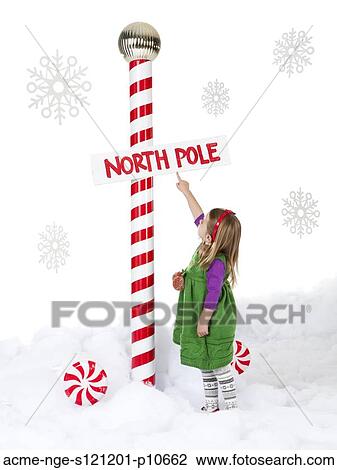 Little girl (18-23 months) standing next to North Pole sign View Large Photo Image Stock Image - Little girl (18-23 months) standing next to North Pole sign. Fotosearch