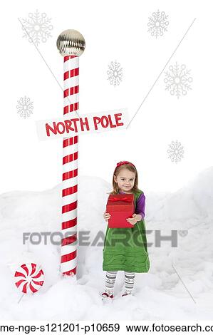 Little girl (18-23 months) standing next to North Pole sign and holding christmas gift View Large Photo Image Stock Photo - Little girl (18-23 months) standing next to North Pole sign and holding christmas gift. Fotosearch