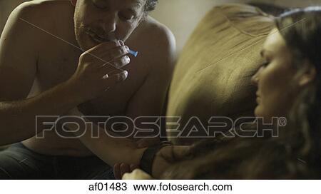 Low angle view of drug addict loading syringe needle for injection with tourniquet View Large Photo Image Stock Image - Low angle view of drug addict loading syringe needle for injection with tourniquet. Fotosearch