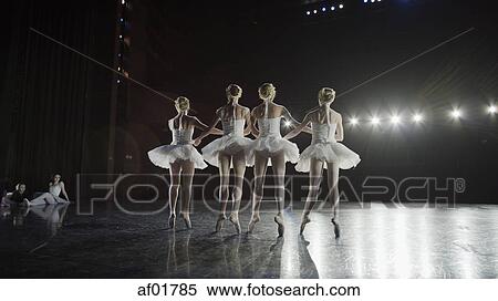 Low angle view of serious ballet dancers in costume performing onstage in show View Large Photo Image Stock Photography - Low angle view of serious ballet dancers in costume performing onstage in show. Fotosearch