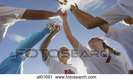 Low angle view of soccer team players cheering in huddle before game under clear blue sky View Large Photo Image Stock Image - Low angle view of soccer team players cheering in huddle before game under clear blue sky. Fotosearch