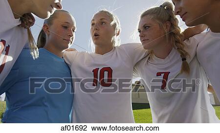 Low angle view of soccer team players talking in huddle before game under blue sky View Large Photo Image Stock Image - Low angle view of soccer team players talking in huddle before game under blue sky. Fotosearch