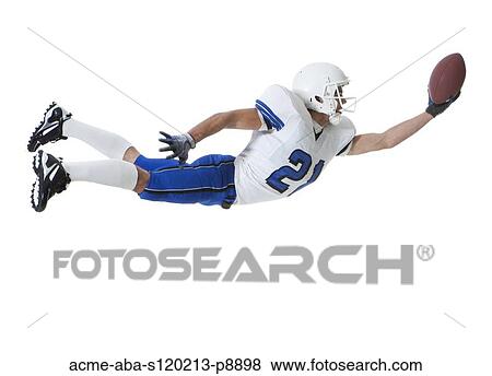 Male player of American football catching ball, studio shot View Large Photo Image Stock Photo - Male player of American football catching ball, studio shot. Fotosearch