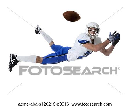 Male player of American football catching ball, studio shot View Large Photo Image Stock Photograph - Male player of American football catching ball, studio shot. Fotosearch