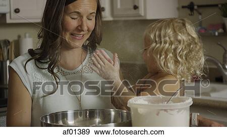 Mother and daughter playing with flour and learning to bake in kitchen View Large Photo Image Stock Photo - Mother and daughter playing with flour and learning to bake in kitchen. Fotosearch