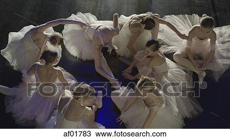 Overhead view of serious ballet dancers in costume stretching backstage during show View Large Photo Image Stock Image - Overhead view of serious ballet dancers in costume stretching backstage during show. Fotosearch