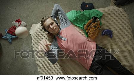 Overhead view of teenage boy listening to headphones and laying on bed View Large Photo Image Stock Image - Overhead view of teenage boy listening to headphones and laying on bed. Fotosearch