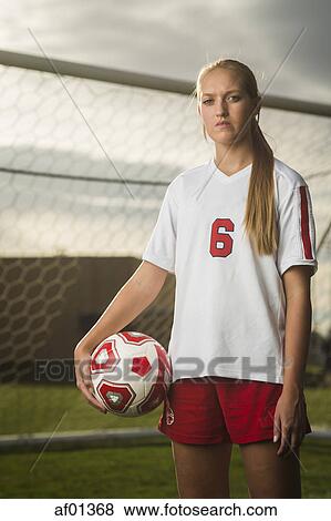 Portrait of athlete standing with ball in soccer goal under cloudy sky View Large Photo Image Stock Photo - Portrait of athlete standing with ball in soccer goal under cloudy sky. Fotosearch