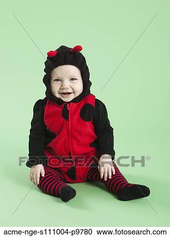 Portrait of baby girl (6-11 months) in ladybird costume for Halloween View Large Photo Image Stock Image - Portrait of baby girl (6-11 months) in ladybird costume for Halloween. Fotosearch