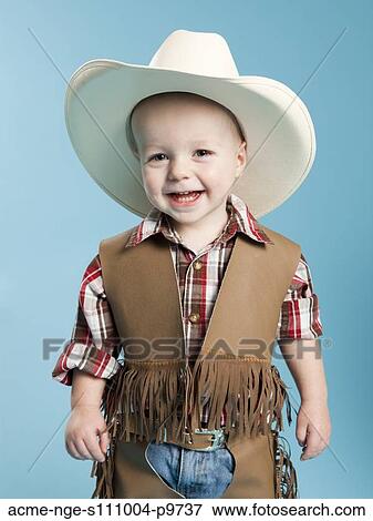Portrait of boy (12-17 months) in cowboy costume for Halloween View Large Photo Image Stock Photo - Portrait of boy (12-17 months) in cowboy costume for Halloween. Fotosearch