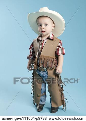 Portrait of boy (12-17 months) in cowboy costume for Halloween View Large Photo Image Stock Photo - Portrait of boy (12-17 months) in cowboy costume for Halloween. Fotosearch
