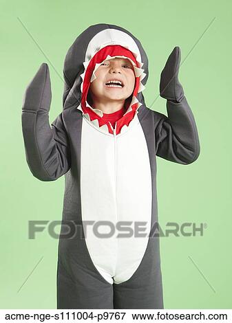 Portrait of boy (6-7) in shark costume for Halloween View Large Photo Image Stock Photo - Portrait of boy (6-7) in shark costume for Halloween. Fotosearch