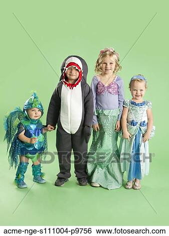 Portrait of children (12-17 months) and (2-7) in Mermaid and fish costumes for Halloween View Large Photo Image Stock Photograph - Portrait of children (12-17 months) and (2-7) in Mermaid and fish costumes for Halloween. Fotosearch