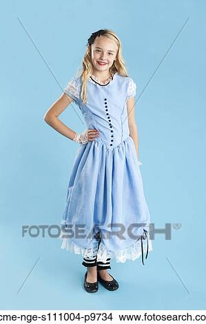Portrait of girl (10-11) in Alice in Wonderland costume for Halloween View Large Photo Image Picture - Portrait of girl (10-11) in Alice in Wonderland costume for Halloween. Fotosearch