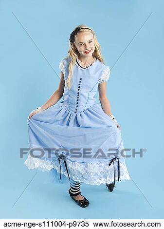 Portrait of girl (10-11) in Alice in Wonderland costume for Halloween View Large Photo Image Stock Photography - Portrait of girl (10-11) in Alice in Wonderland costume for Halloween. Fotosearch