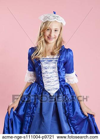 Stock Image - Portrait of girl (10-11) in colonial princess dress for Halloween. Fotosearch