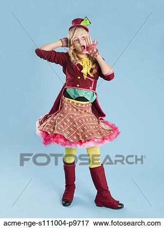 Stock Photo - Portrait of girl (10-11) in Mad Hatter costume for Halloween. Fotosearch