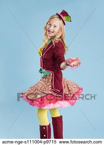 Stock Photography - Portrait of girl (10-11) in Mad Hatter costume for Halloween. Fotosearch