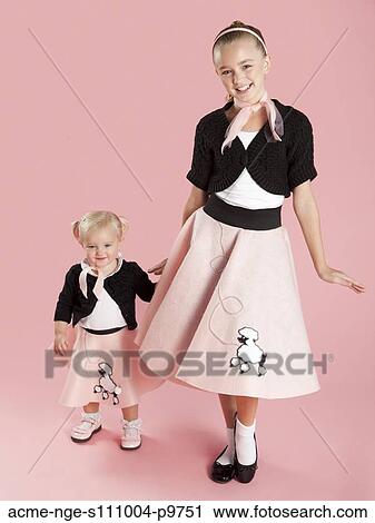 Portrait of girls (12-17 months) and (10-11) in 1950s style costumes for Halloween View Large Photo Image Stock Image - Portrait of girls (12-17 months) and (10-11) in 1950s style costumes for Halloween. Fotosearch