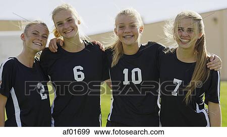 Portrait of proud soccer teammates in uniforms hugging outdoors View Large Photo Image Stock Photo - Portrait of proud soccer teammates in uniforms hugging outdoors. Fotosearch