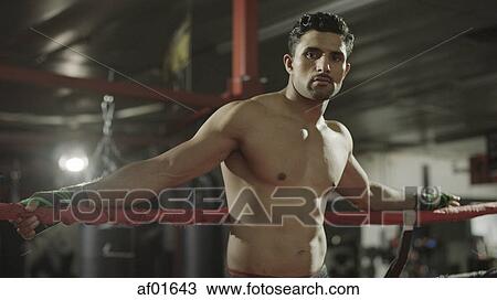 Portrait of serious boxer standing in boxing ring View Large Photo Image Stock Image - Portrait of serious boxer standing in boxing ring. Fotosearch