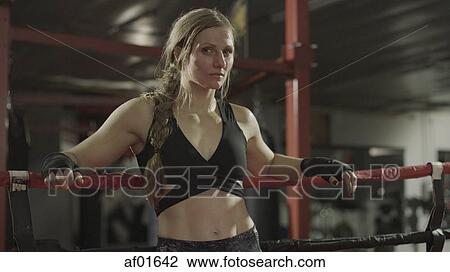 Portrait of serious female boxer standing in boxing ring View Large Photo Image Stock Image - Portrait of serious female boxer standing in boxing ring. Fotosearch