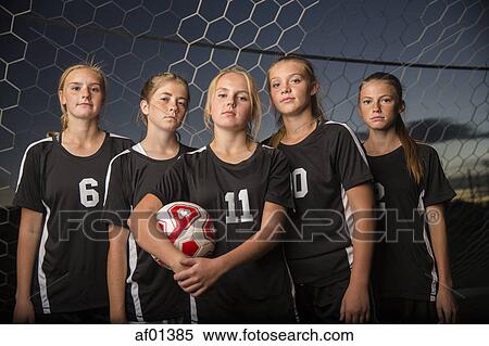 Portrait of serious soccer team standing in goal under sunset sky View Large Photo Image Stock Photography - Portrait of serious soccer team standing in goal under sunset sky. Fotosearch
