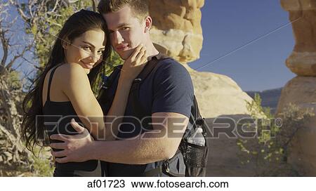 Portrait of smiling boyfriend and girlfriend hugging near scenic rock formations View Large Photo Image Stock Image - Portrait of smiling boyfriend and girlfriend hugging near scenic rock formations. Fotosearch