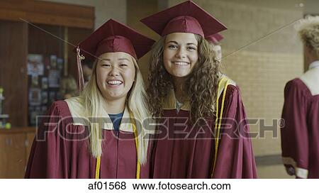 Portrait of smiling students posing at graduation View Large Photo Image Stock Photo - Portrait of smiling students posing at graduation. Fotosearch