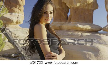 Portrait of smiling woman standing near scenic rock formations View Large Photo Image Stock Image - Portrait of smiling woman standing near scenic rock formations. Fotosearch