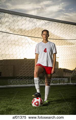 Portrait of soccer player standing with ball in goal under sunset sky View Large Photo Image Stock Photography - Portrait of soccer player standing with ball in goal under sunset sky. Fotosearch