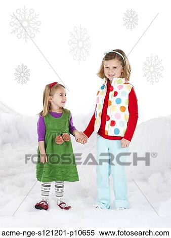 Stock Photography - Portrait of two girls (18-23 months, 6-7) holding hands. Fotosearch